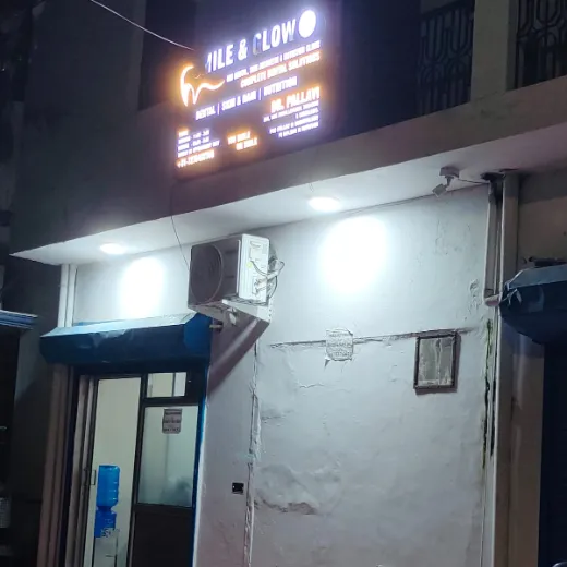 Smile & Glow clinic entrance with lit signboard